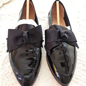Kate Spade patent leather loafers with bows.